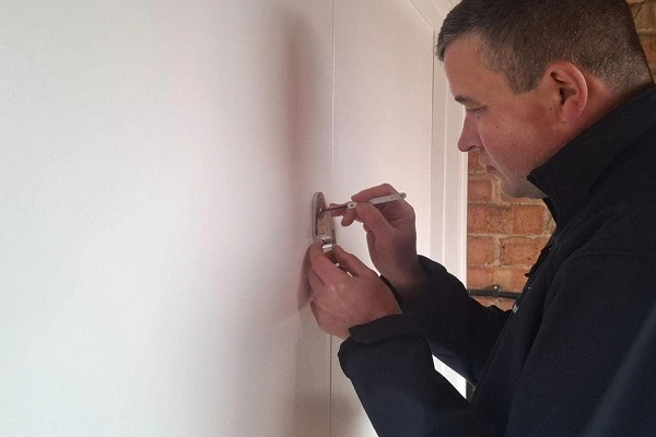 Commercial locksmith using non-destructive lock picking to regain access to business premises.